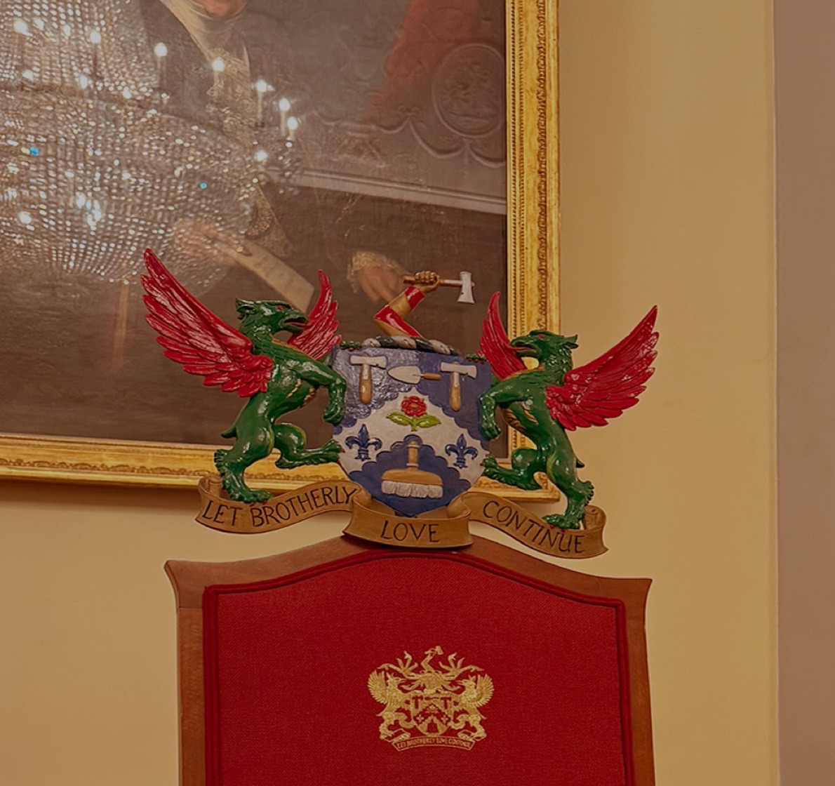 Master's chair beneath a livery company coat of arms