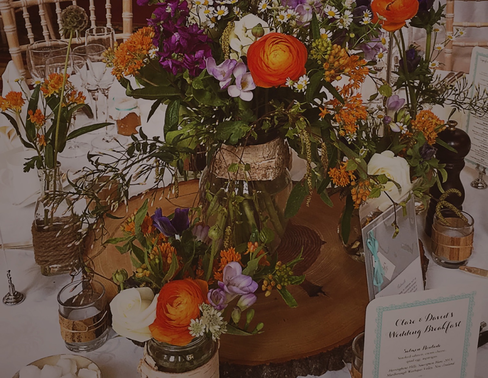 Round table centrepiece with ranunculus and wild flowers
